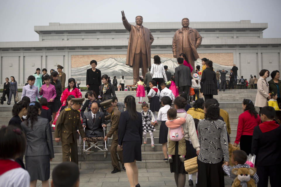 North Koreans arrive at Pyongyang's Mansu Hill to pay their respects to bronze statues of the late leaders Kim Il Sung and Kim Jong Il at Munsu Hill in Pyongyang on Tuesday, April 15, 2014, the official birthday of Kim Il Sung. (AP Photo/David Guttenfelder)