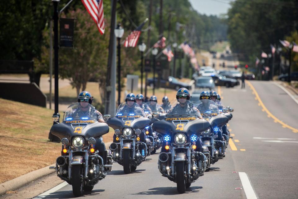 A motorcade leaves the Rankin County Courthouse in Brandon, Miss., moving west on U.S. Hwy. 80, carrying six former Rankin County law enforcement officers who pleaded guilty to state charges for torturing two Black men in a racist assault that occurred in Rankin County in January. All six had recently admitted their guilt in a connected federal civil rights case.