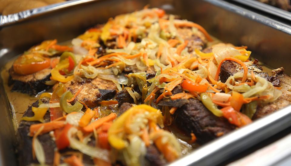 Pictured here is the escovitch fish from Jamaican Mama Cuisine inside the Saraga International Market.