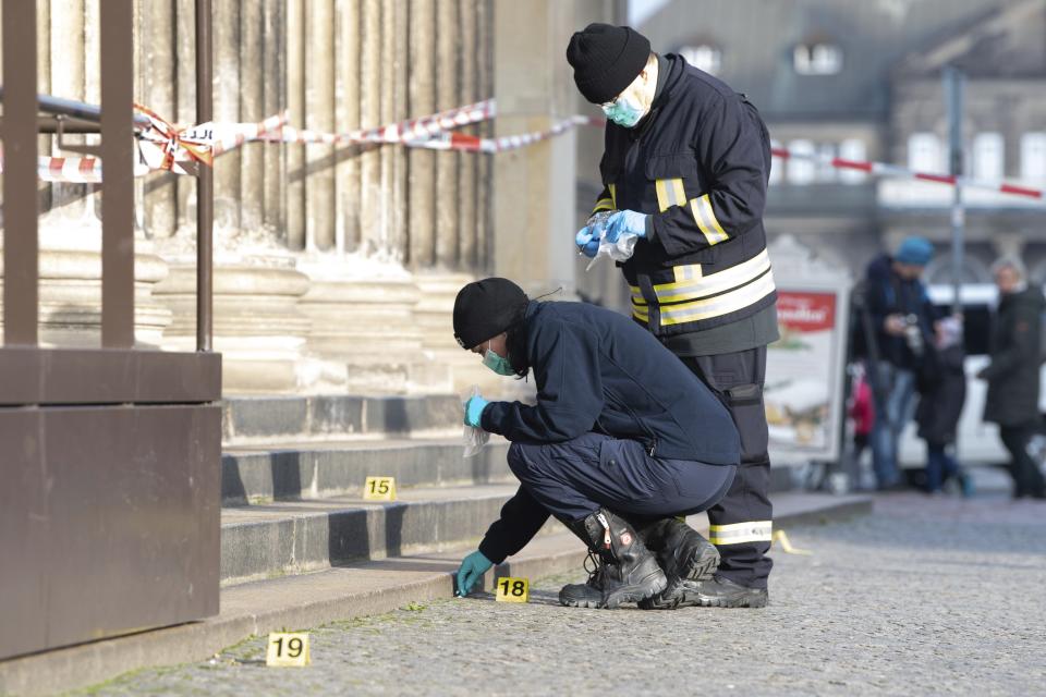 Police officers work behind a caution tape at the Schinkelwache building in Dresden Monday, Nov. 25, 2019. Authorities in Germany say thieves have carried out a brazen heist at Dresden’s Green Vault, one of the world’s oldest museum containing priceless treasures from around the world. (Sebastian Kahnert/dpa via AP)