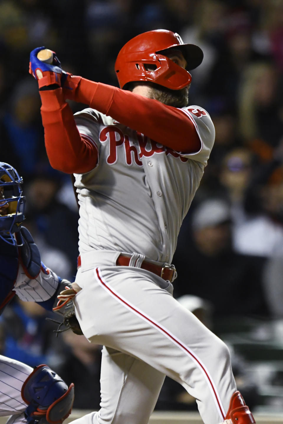 Philadelphia Phillies' Bryce Harper watches his RBI double during the sixth inning of the team's baseball game against the Chicago Cubs on Tuesday, Sept. 27, 2022, in Chicago. (AP Photo/Paul Beaty)