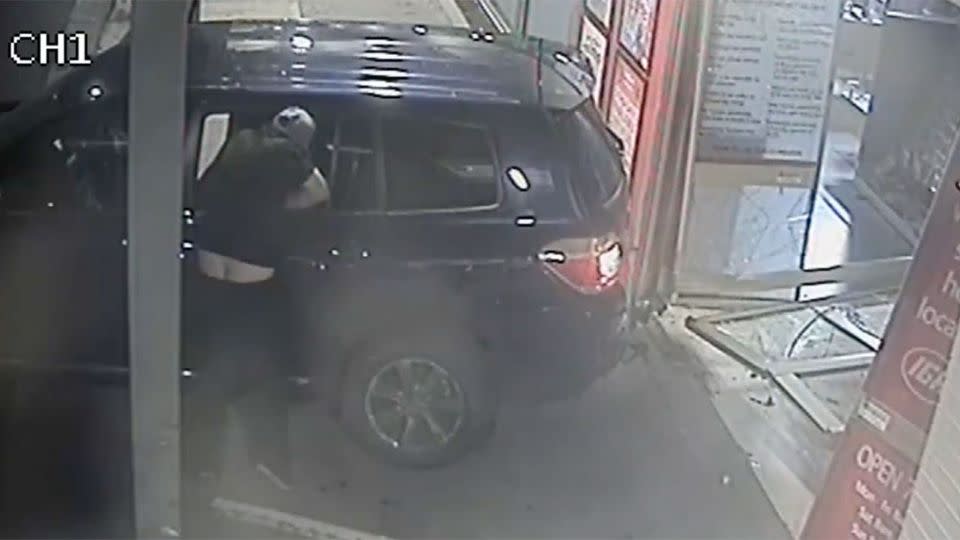 This is the stolen Toyoa Kluger the brazen thief, who is in clear need of a belt, used to smash his way through an Epping supermarket. Photo: Victorian Police