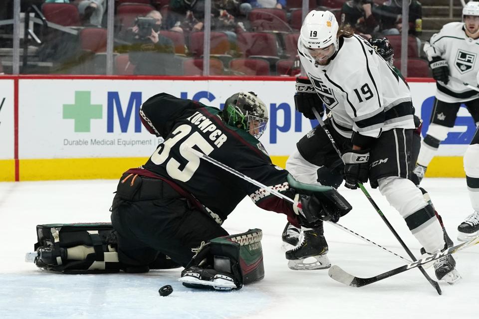 Los Angeles Kings right wing Alex Iafallo (19) beats Arizona Coyotes goaltender Darcy Kuemper (35) for a goal during the second period of an NHL hockey game Monday, May 3, 2021, in Glendale, Ariz. (AP Photo/Ross D. Franklin)
