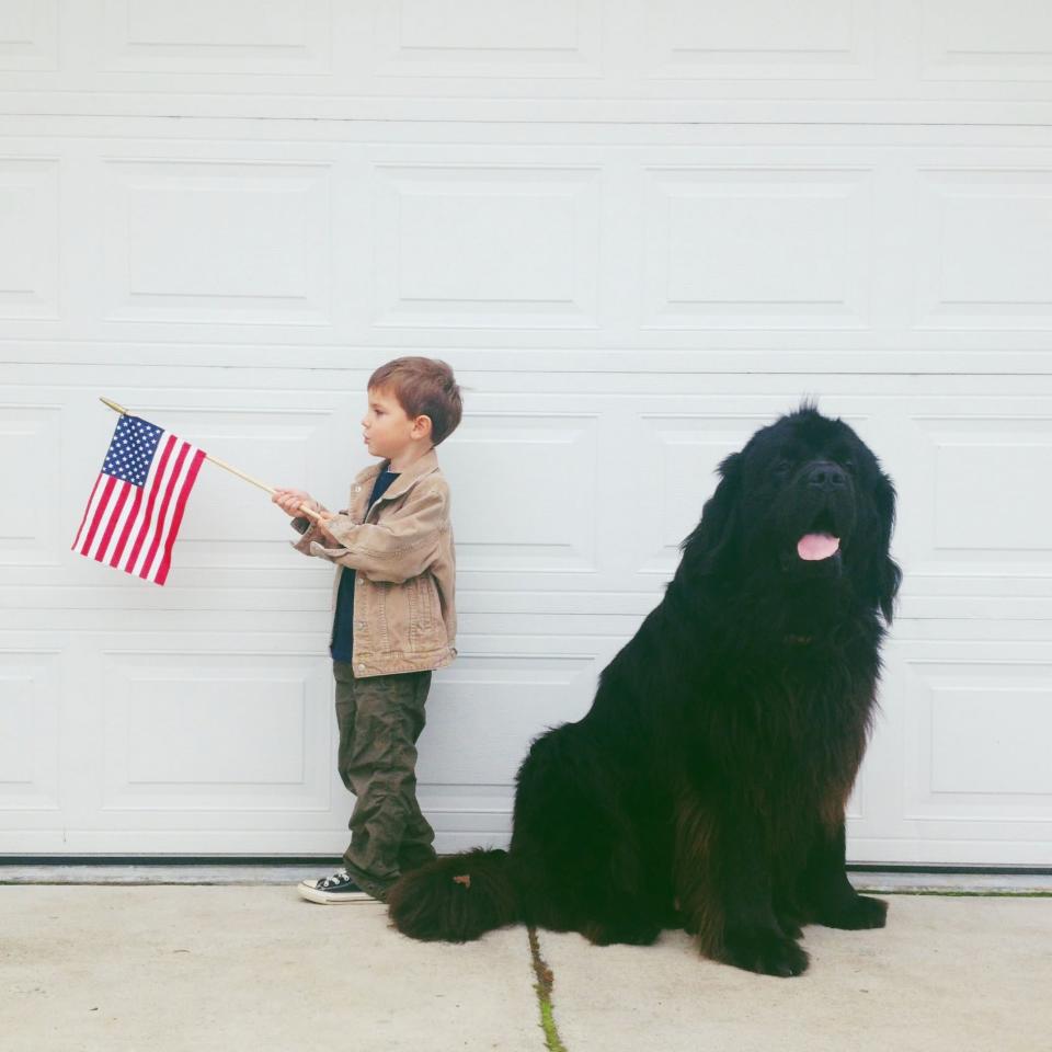 Julian waves the American flag while Max drools for the camera. (Photo: Stasha Becker/Rex Features)