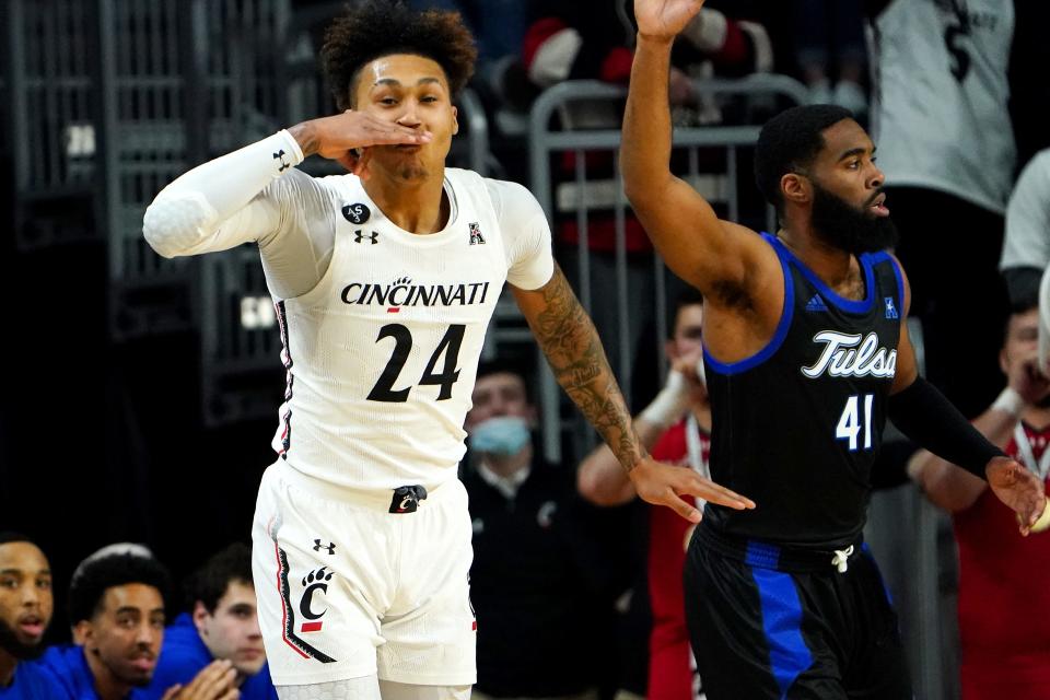 Cincinnati Bearcats guard Jeremiah Davenport (24) reacts after a made three-point basket in the first half of an NCAA men&#39;s college basketball game against the Tulsa Golden Hurricane, Thursday, Jan. 20, 2022, at Fifth Third Arena in Cincinnati.