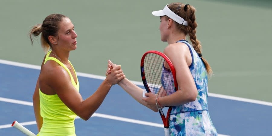 Kostyuk and Rybakina sharea handshake