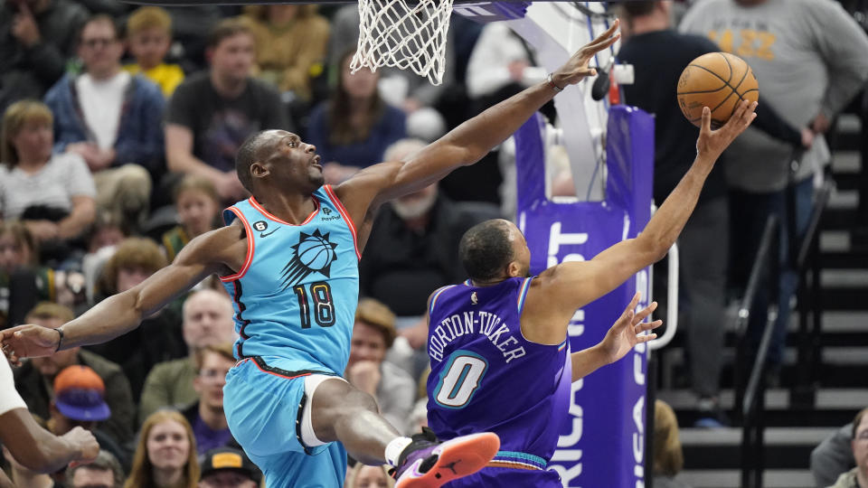 Phoenix Suns center Bismack Biyombo (18) defends against Utah Jazz guard Talen Horton-Tucker (0) during the second half of an NBA basketball game Monday, March 27, 2023, in Salt Lake City. (AP Photo/Rick Bowmer)