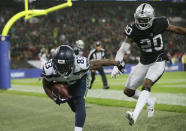 Seattle Seahawks wide receiver David Moore (83) stumbles out of the end zone after scoring a touchdown during the first half of an NFL football game at Wembley stadium in London, Sunday, Oct. 14, 2018. (AP Photo/Tim Ireland)