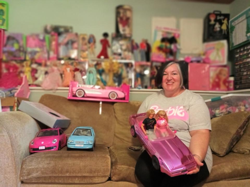 Melinda Umezaki, 44, poses with a small portion of her Barbie collection. She estimates she owns somewhere between 250 to 300 Barbie dolls.