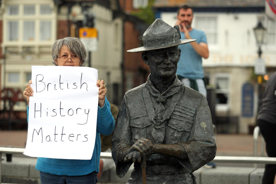 A person with a sign protesting 'British History Matters' alongside the statue of Robert Baden-Powell on Poole Quay in Dorset. The statue is due to be removed and placed in "safe storage" following concerns about his actions while in the military and "Nazi sympathies". The action follows a raft of Black Lives Matter protests across the UK, sparked by the death of George Floyd, who was killed on May 25 while in police custody in the US city of Minneapolis.