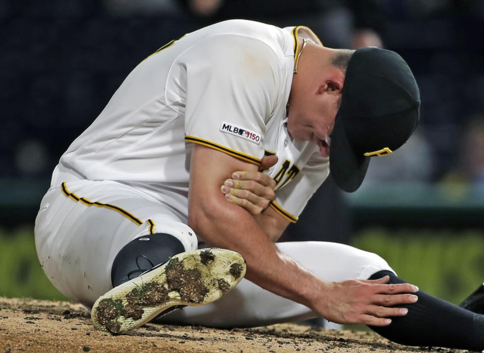 FILE - In this April 22, 2019, file photo, Pittsburgh Pirates relief pitcher Nick Burdi holds his right arm after delivering a pitch during the eighth inning of a baseball game against the Arizona Diamondbacks in Pittsburgh. Burdi is back with the Pirates, one rib lighter and optimistic his issues with thoracic outlet syndrome are behind him. (AP Photo/Gene J. Puskar, File)