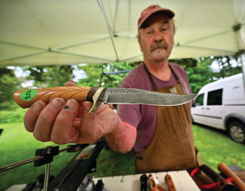 A vintage knife made of Damascus steel is amongst the selection of blades for sale by knife sharpener David Morrison at the Holden Farmers Market.