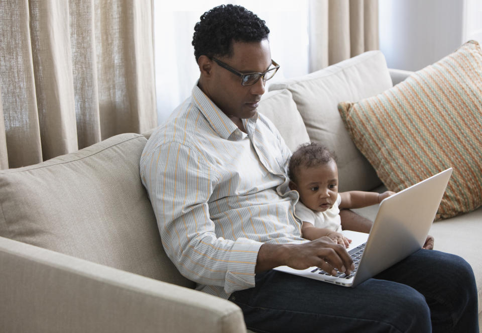 Father working from home and taking care of baby