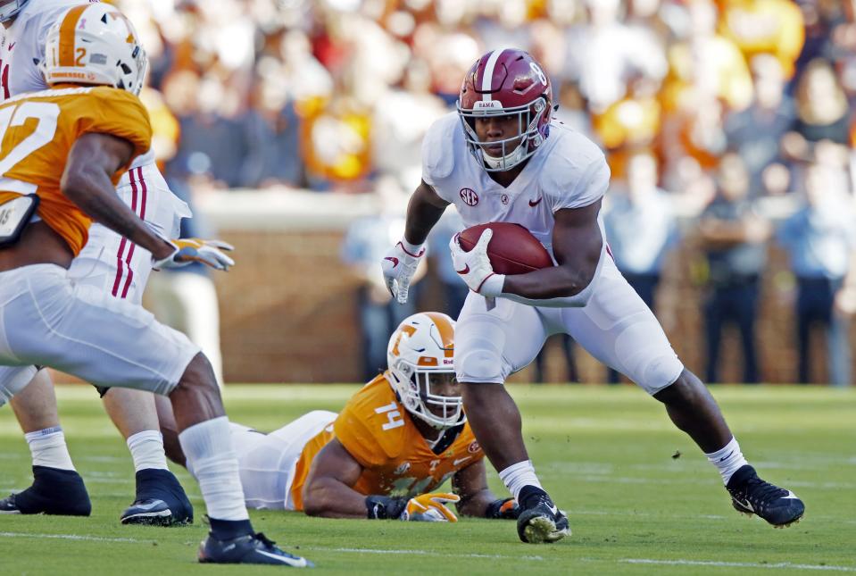 Alabama running back Josh Jacobs (8) runs for yardage as he is missed by Tennessee linebacker Quart'e Sapp (14) in the first half of an NCAA college football game Saturday, Oct. 20, 2018, in Knoxville, Tenn. (AP Photo/Wade Payne)