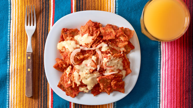 Red sauce on tortillas on white plate 