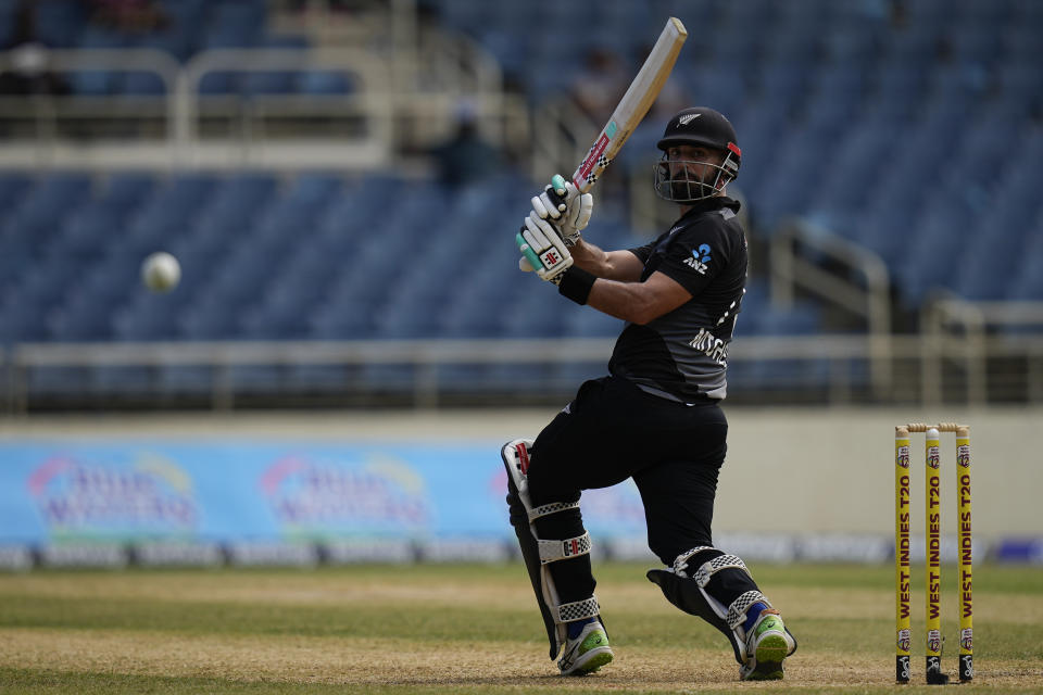 New Zealand's Daryl Mitchell plays a shot against the West Indies during the third T20 cricket match at Sabina Park in Kingston, Jamaica, Sunday, Aug. 14, 2022. (AP Photo/Ramon Espinosa)