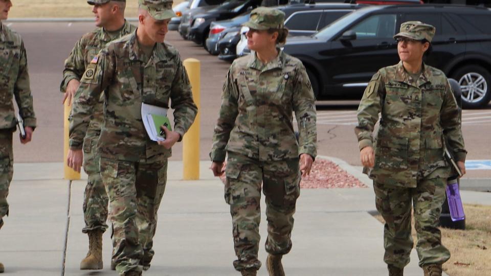 Then-Brig. Gen. Douglas Stitt (left), is greeted by Maj. Korneliya S. Waters, (middle), brigade personnel management officer, 4th Sustainment Brigade, 4th Infantry Division on Fort Carson, Colorado, November 15, 2018. (Sgt. James Geelen/Army)