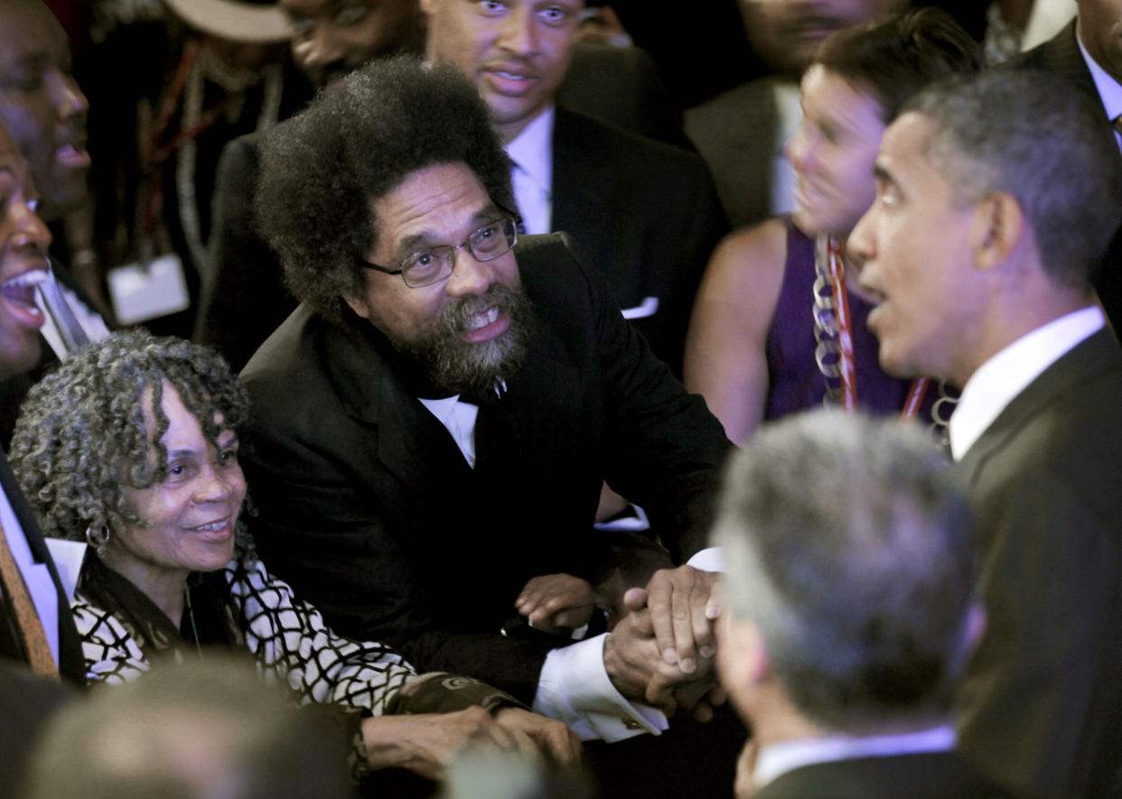 Barack Obama shakes hands with Cornel West and Sonia Sanchez.