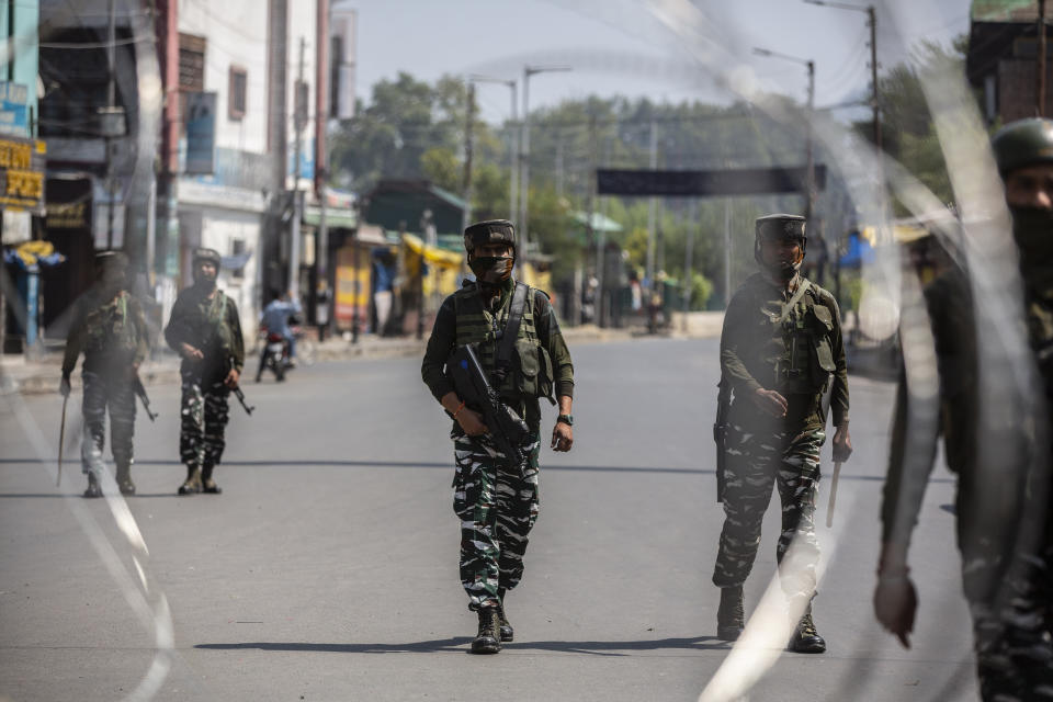 Indian paramilitary soldiers patrol a deserted market area in Srinagar, Indian controlled Kashmir, Thursday, Sept. 2, 2021. Indian authorities cracked down on public movement and imposed a near-total communications blackout Thursday in disputed Kashmir after the death of Syed Ali Geelani, a top separatist leader who became the emblem of the region’s defiance against New Delhi. Geelani, who died late Wednesday at age 91, was buried in a quiet funeral organized by authorities under harsh restrictions, his son Naseem Geelani told The Associated Press. He said the family had planned the burial at the main martyrs’ graveyard in Srinagar, the region’s main city, as per his will but were disallowed by police. (AP Photo/ Mukhtar Khan)