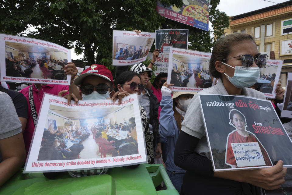 Supporters hold a portrait of NagaWorld's union leader Chhim Sithar during a protest in front of Phnom Penh Municipal Court in Phnom Penh, Cambodia, Thursday, May 25, 2023. Chhim Sithar who led a long-running strike against Cambodia’s biggest casino was sentenced Thursday to two years in prison for incitement to commit a felony, while eight fellow union members received lesser terms that do not include time behind bars. (AP Photo/Heng Sinith)