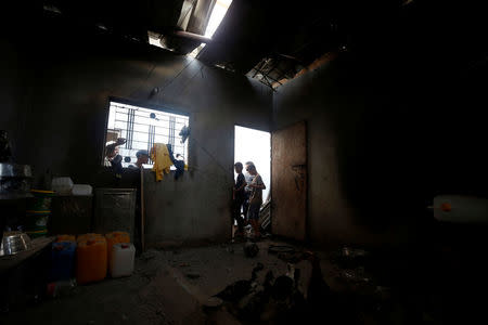 Palestinians inspect a house damaged in an Israeli air strike in Al-Mughraqa on the outskirts of Gaza City August 9, 2018. REUTERS/Mohammed Salem