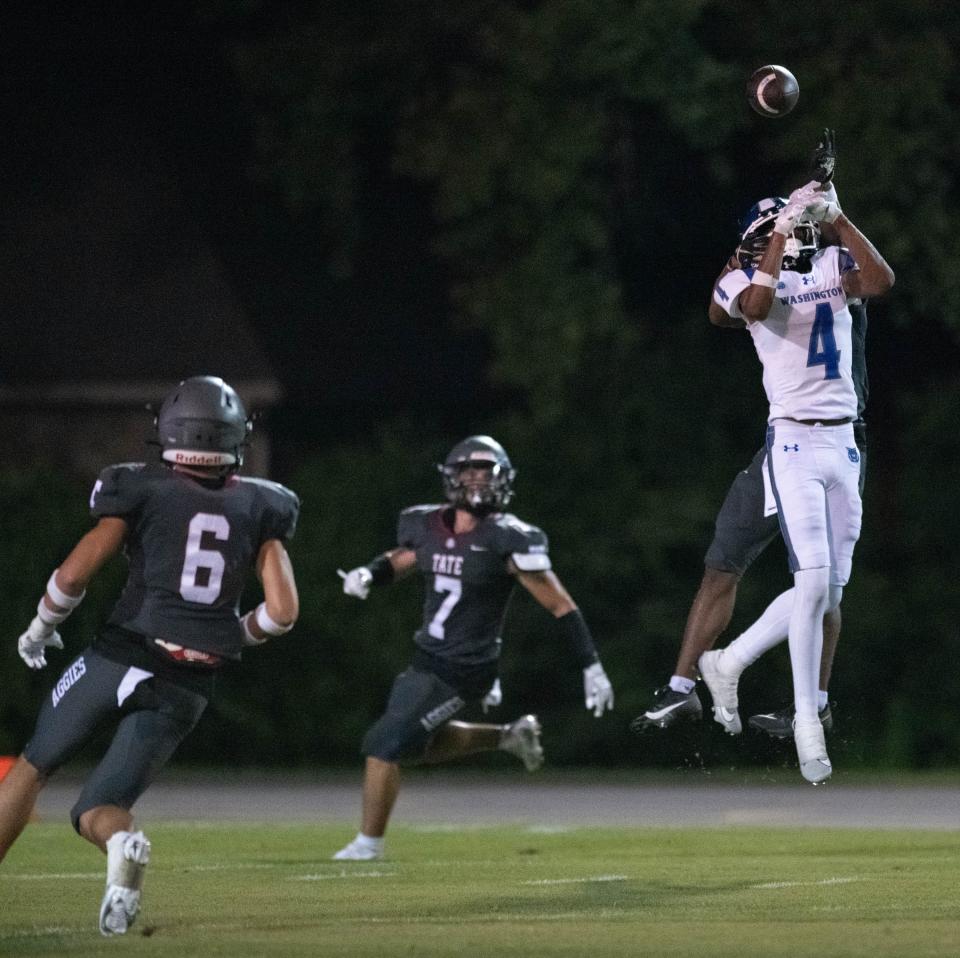 The pass intended for Tamyron Thomas (4) is broken up by Christian Neptune (1) and intercepted by Nathan Shimek (6) during the Booker T. Washington vs Tate football Kickoff Classic at Tate High School in Cantonment on Thursday, Aug. 17, 2023.