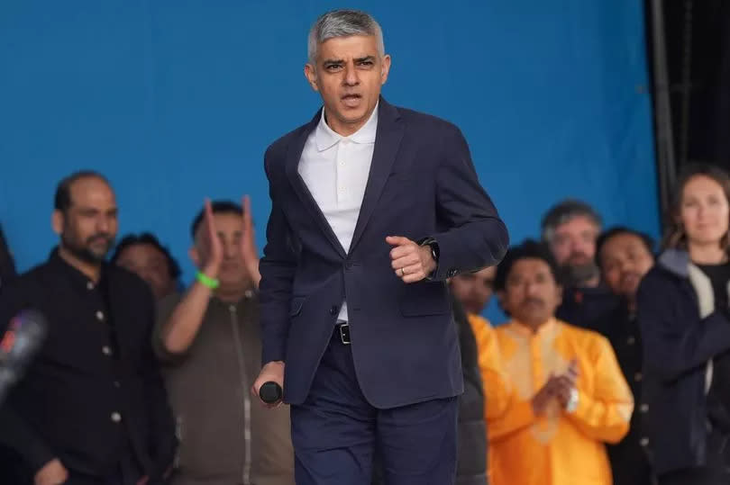 Mayor of London Sadiq Khan running onto a stage