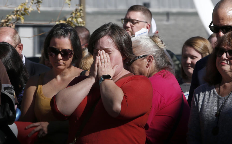 Laura Smith, center, holds her head in her hands during the 85 seconds of silence to honor the 85 people who died in last year's Camp Fire during ceremonies in Paradise, Calif., Friday, Nov. 8, 2019. Friday marks the one year anniversary of the wildfire that nearly destroyed the entire town. (AP Photo/Rich Pedroncelli)