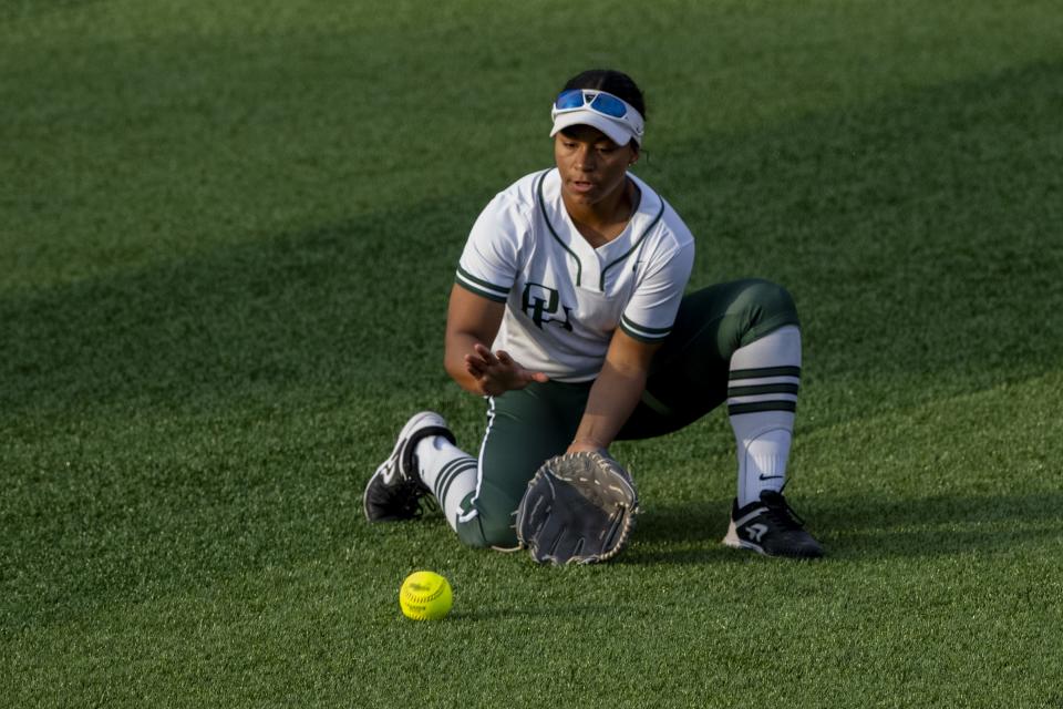 Pendleton Heights High School junior Ari Rector (9) fields a ground ball hit into center field during an IHSAA softball game against Center Grove High School, Friday, March 29, 2024. Host Center Grove won, 7-6.