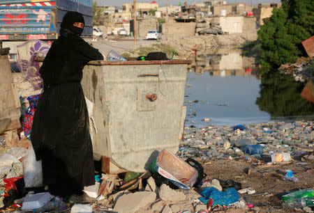 A woman gathers garbage near one of the rivers extending to Shatt al-Arab in Basra, Iraq September 10, 2018. REUTERS/Essam al-Sudani/Files