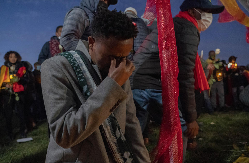 Angesom cries after offering flowers during an event in Washington on Thursday, Nov. 4, 2021, to commemorate Gebrehiwot Yemane and Haben Sahle Newfie, his two-nephews who were among the people killed in Ethiopia Prime Minister Abiy Ahmed's administration's attacks in Tigray, the northernmost region in Ethiopia. (AP Photo/Gemunu Amarasinghe)