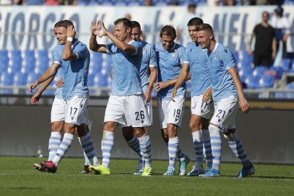 Lazio's Stefan Radu, center, number 26, celebrates after scoring his side's second goal during a Serie A soccer match between Lazio and Genoa, at the Rome Olympic Stadium, Sunday, Sept. 29, 2019. (AP Photo/Andrew Medichini)