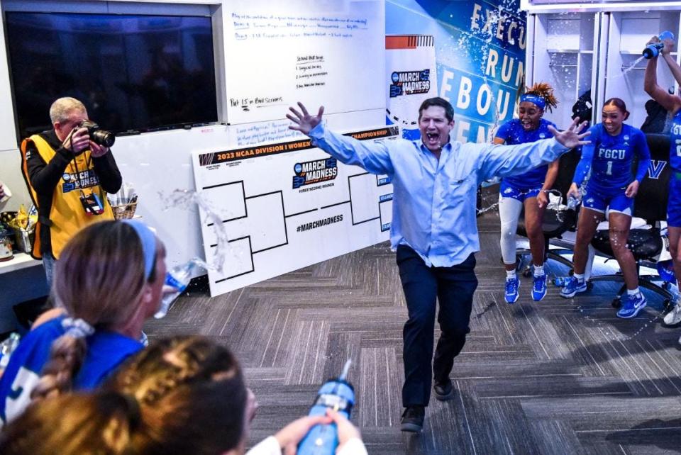 FGCU coach Karl Smesko celebrates in the locker room after the Eagles' first-round 2023 NCAA Tournament win over Washington State in Villanova, Pa. on Saturday.