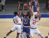 Golden State Warriors forward Eric Paschall (7) is defended by New York Knicks guard Immanuel Quickley (5) and center Taj Gibson (67) during the first half of an NBA basketball game Tuesday, Feb. 23, 2021, in New York. (Wendell Cruz/Pool Photo via AP)