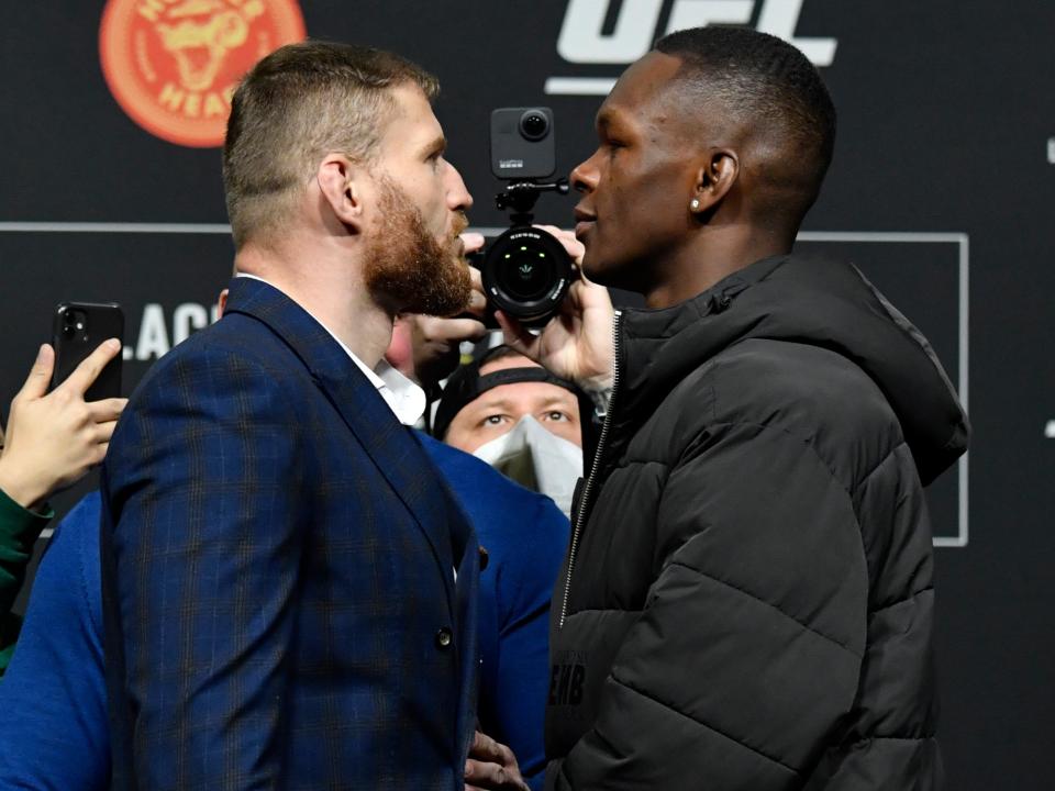 UFC light heavyweight champion Jan Blachowicz (left) and middleweight titleholder Israel Adesanya (Zuffa LLC via Getty Images)