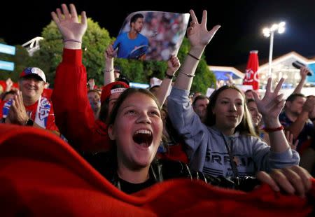 Supporters of Serbia's Novak Djokovic celebrate as they wait for him to appear after he won his final match against Britain's Andy Murray at the Australian Open tennis tournament at Melbourne Park, Australia, January 31, 2016. REUTERS/Jason O'Brien Action Images via Reuters