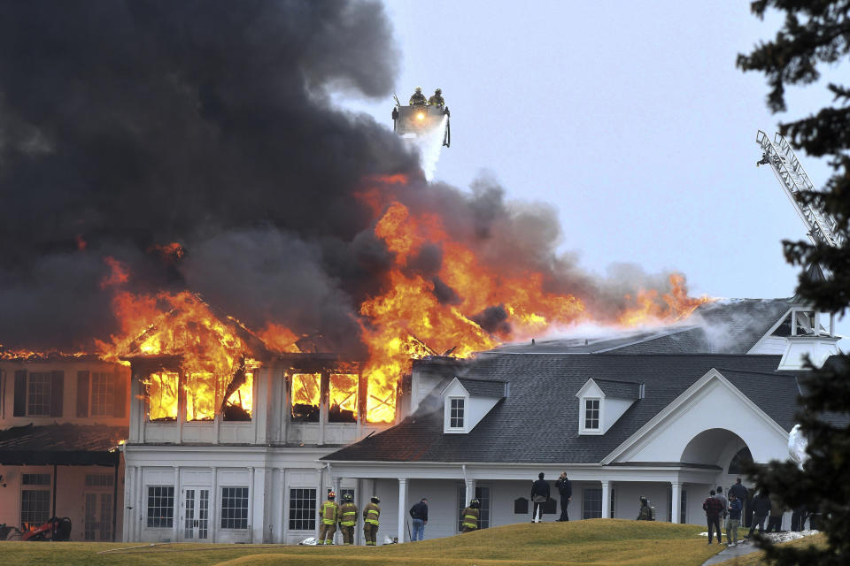 A fire burns at the main building at Oakland Hills Country Club in Bloomfield Township, Mich., on Thursday, Feb. 17, 2022. Firefighters battled a blaze at a more than century-old country club Thursday in suburban Detroit that's hosted several major golf tournaments and is one of Michigan’s most exclusive golf clubs.(Daniel Mears /Detroit News via AP)