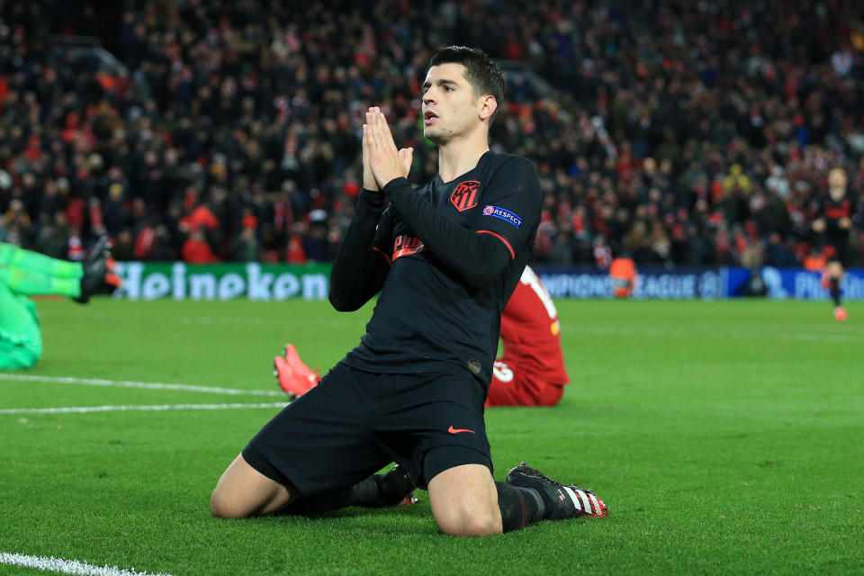 Alvaro Morata of Atletico slides and celebrates his goal after knocking Liverpool out.