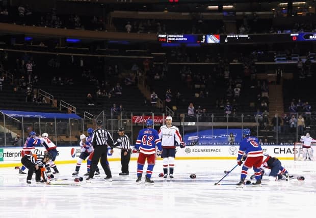 A line brawl erupts off opening puck drop during a game between the Washington Capitals and New York Rangers on Wednesday. (Bruce Bennett/Getty Images - image credit)