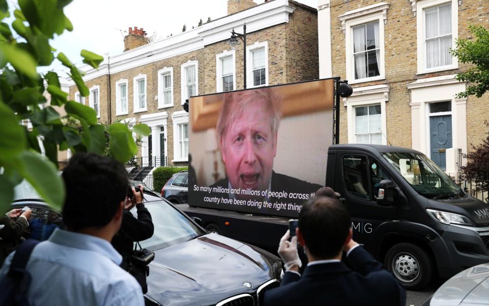 A Led by donkeys truck displaying a video of Britain's Prime Minister Boris Johnson, drives by Dominic Cummings' house in London, following the outbreak of the coronavirus disease (COVID-19), London, Britain, May 24, 2020 - REUTERS