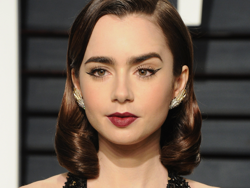 lilly collins negative space eyeliner short curls statement earrings