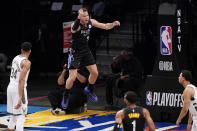 Brooklyn Nets forward Blake Griffin (2) reacts toward the crowd after scoring during the first quarter of Game 2 of an NBA basketball second-round playoff series against the Milwaukee Bucks, Monday, June 7, 2021, in New York. Bucks forward Giannis Antetokounmpo (34) looks on. (AP Photo/Kathy Willens)