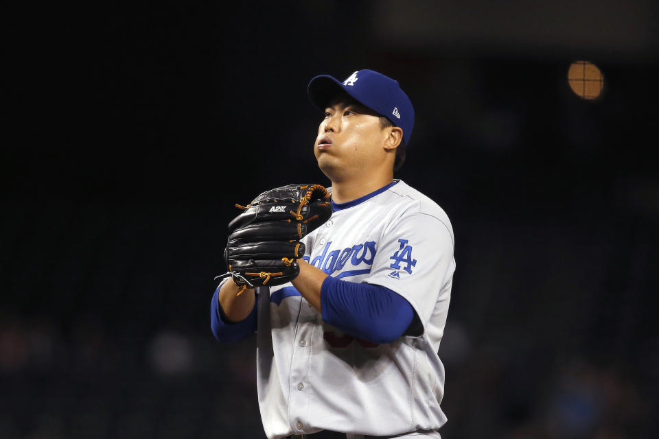 Los Angeles Dodgers starting pitcher Hyun-Jin Ryu, of South Korea, pauses on the mound during the first inning of the team's baseball game against the Arizona Diamondbacks on Thursday, Aug. 29, 2019, in Phoenix. (AP Photo/Ross D. Franklin)