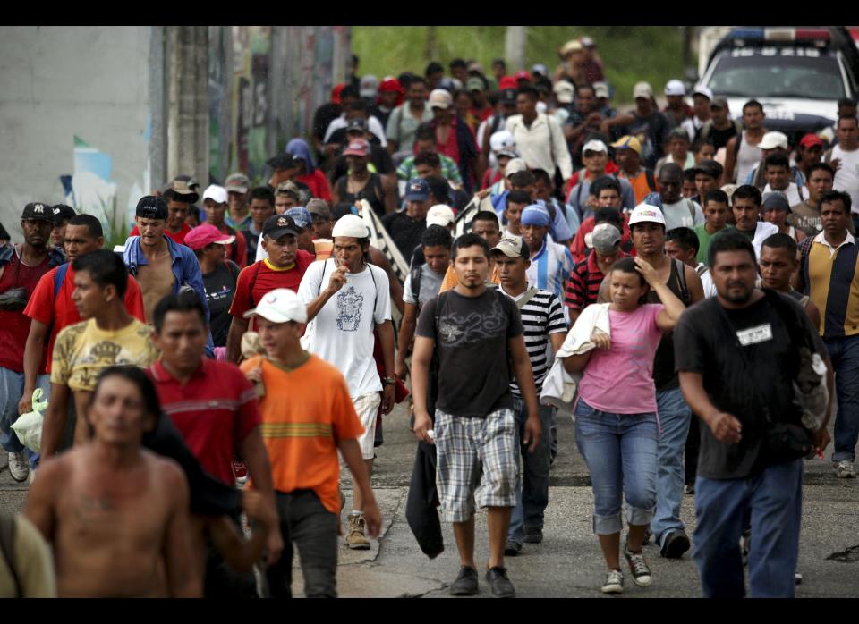 In this photo taken Tuesday, July 10, 2012, hundreds of Central American migrants make their way by foot as they leave the city of Coatzacoalcos, Mexico. Local officials estimate one thousand immigrants are stranded in this town after a rail bridge collapsed blocking the passage of cargo trains used by the travelers heading to the United States. While the number of Mexicans heading to the U.S. has dropped dramatically, a surge of Central American migrants is making the 1,000-mile northbound journey this year, fueled in large part by the rising violence brought by the spread of Mexican drug cartels. (AP Photo/Felix Marquez)