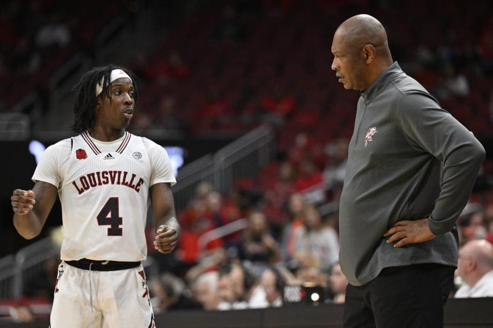 Louisville guard Ty-Laur Johnson (4) talks with head coach Kenny Payne during Sunday’s win over Pepperdine. The Cardinals improved to 5-6 with the victory.