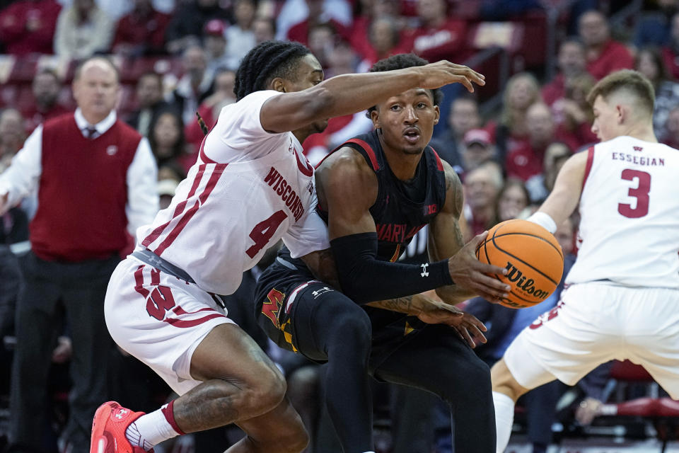Maryland's Jahmir Young (1) maneuvers against Wisconsin's Kamari McGee (4) during the first half of an NCAA college basketball game Tuesday, Dec. 6, 2022, in Madison, Wis. (AP Photo/Andy Manis)
