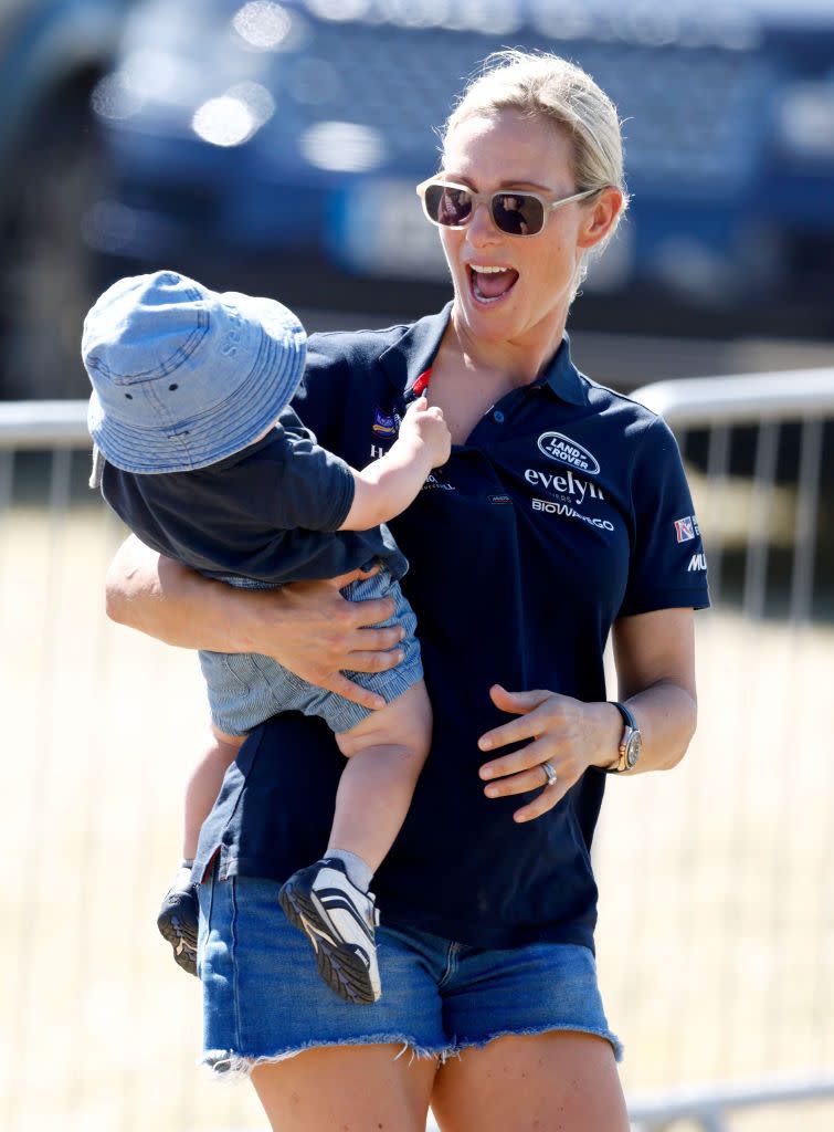 <p>Zara held her youngest, Lucas, at the 2022 Festival of British Eventing at Gatcombe Park.</p>