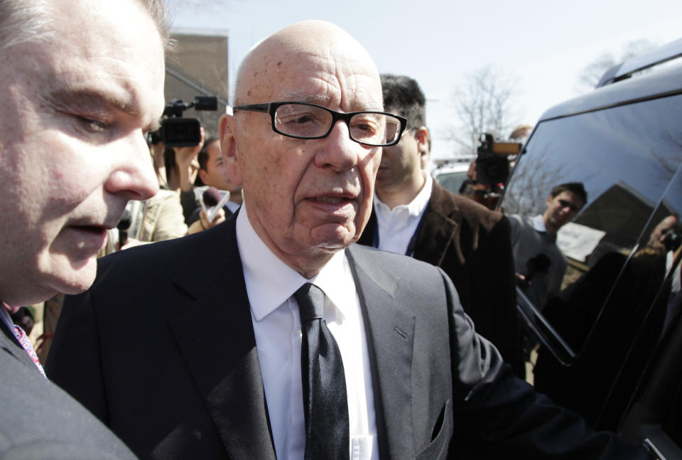 Rupert Murdoch, chairman and CEO of News Corp., leaves after attending the funeral service for journalist Marie Colvin, Monday, March 12, 2012 at St. Dominic Roman Catholic Church in Oyster Bay, N.Y. The 56-year-old Colvin was a longtime reporter for Britain's Sunday Times. She and French photographer Remi Ochlik were killed Feb. 22 in shelling in Homs, Syria. (AP Photo/Mark Lennihan)