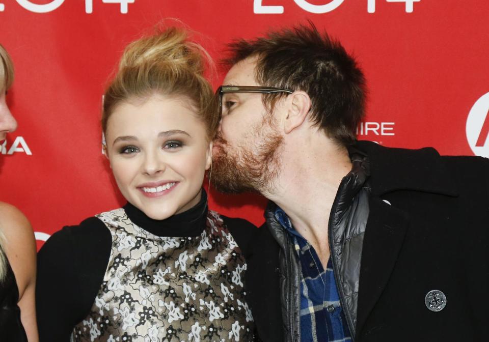 Actor Sam Rockwell, right, kisses fellow cast member Chloe Grace Moretz, as they pose at the premiere of the film "Laggies" during the 2014 Sundance Film Festival, on Friday, Jan. 17, 2014, in Park City, Utah. (Photo by Danny Moloshok/Invision/AP)