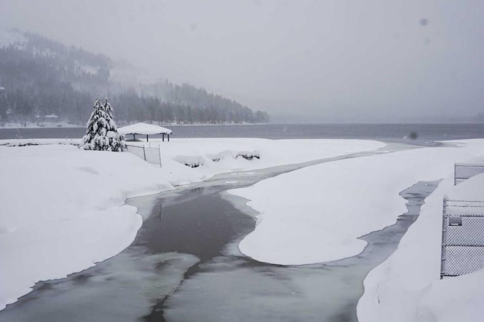 Snow covers the shore on Donner Lake, Saturday, March 2, 2024, in Truckee, Calif. A powerful blizzard howled Saturday in the Sierra Nevada as the biggest storm of the season shut down a long stretch of Interstate 80 in California and gusty winds and heavy rain hit lower elevations, leaving tens of thousands of homes without power.